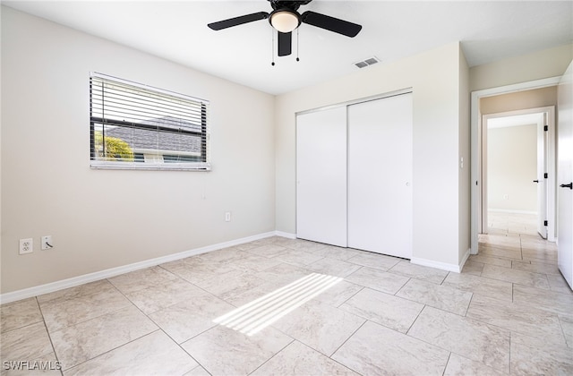 unfurnished bedroom with a closet and ceiling fan