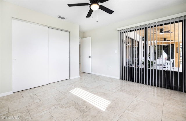 unfurnished bedroom with a closet and ceiling fan