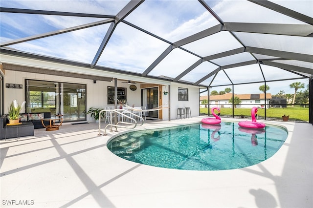 view of swimming pool with ceiling fan, a patio, and a lanai