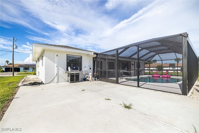 back of property with a patio area and a lanai