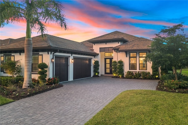 view of front of home featuring a lawn and a garage