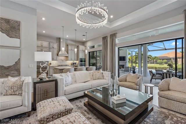 living room featuring an inviting chandelier and crown molding