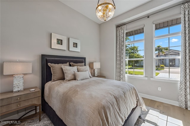 bedroom featuring multiple windows and hardwood / wood-style floors