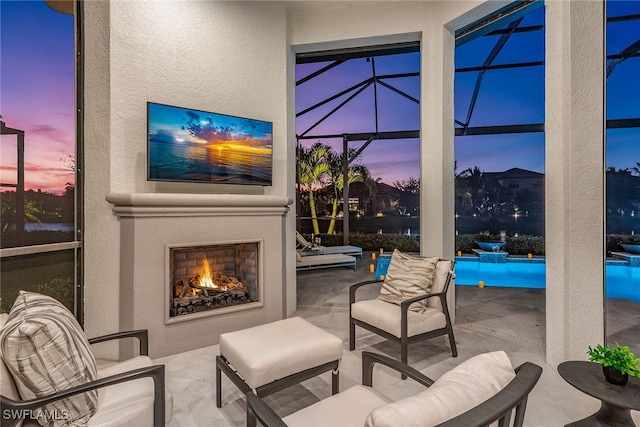 view of patio / terrace with glass enclosure and exterior fireplace