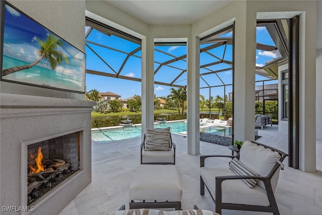 view of patio / terrace featuring a lanai and exterior fireplace