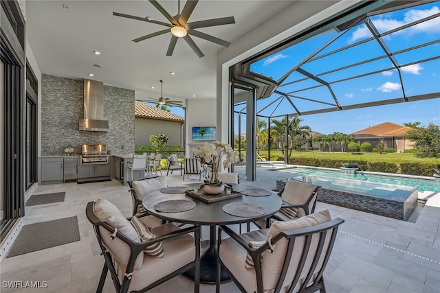 view of patio with a lanai, area for grilling, ceiling fan, and grilling area