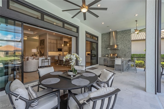 view of patio / terrace with ceiling fan, area for grilling, and an outdoor kitchen