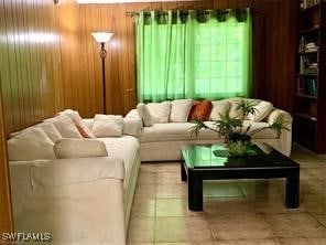 tiled living room with wooden walls