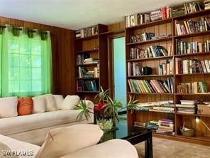 601 E Del Monte Ave, Clewiston, FL 33440 - sitting room featuring bookshelves and wooden walls