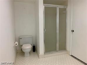 bathroom with toilet and a shower with shower door