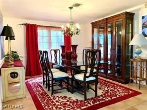 tiled dining space featuring a chandelier