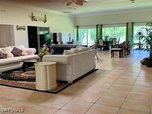 living room featuring ornamental molding, ceiling fan, and light tile patterned floors