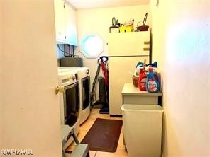 washroom featuring water heater and separate washer and dryer