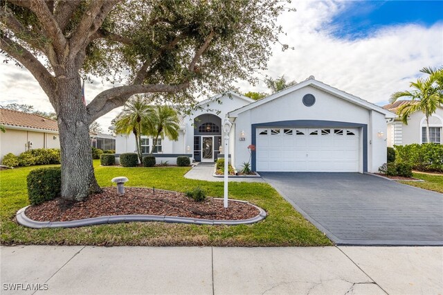 view of front of house with a garage and a front lawn