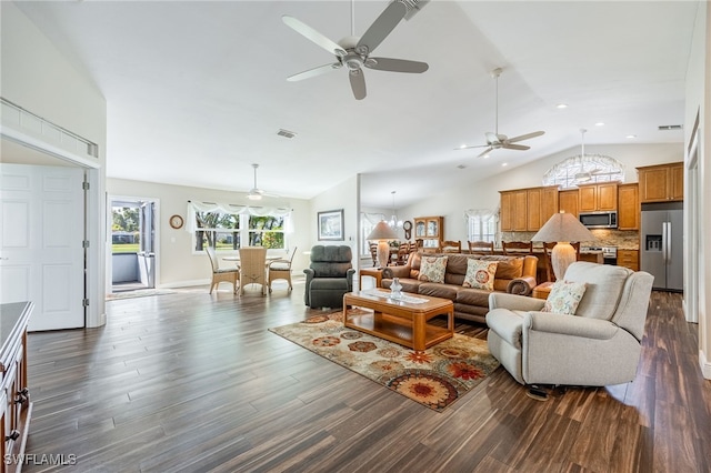 living area with high vaulted ceiling, dark wood finished floors, and visible vents