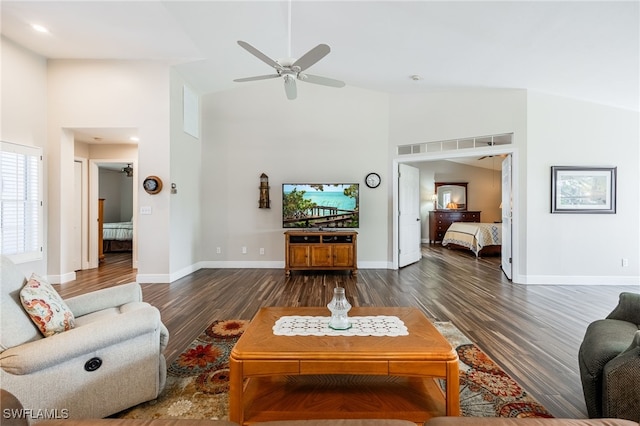 living room featuring a ceiling fan, baseboards, high vaulted ceiling, and dark wood-style flooring