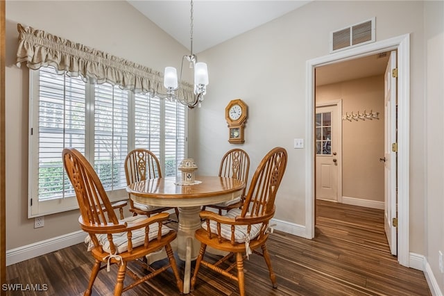 dining room with baseboards, visible vents, lofted ceiling, dark wood-style flooring, and an inviting chandelier