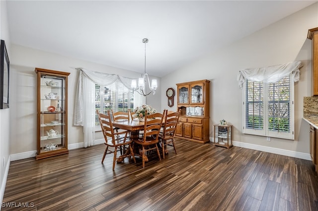 dining area with lofted ceiling, dark wood-style flooring, baseboards, and an inviting chandelier