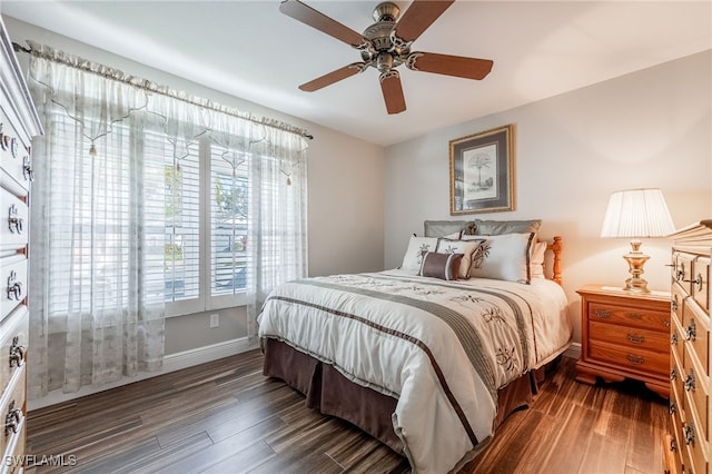 bedroom featuring dark wood-style floors, ceiling fan, and baseboards