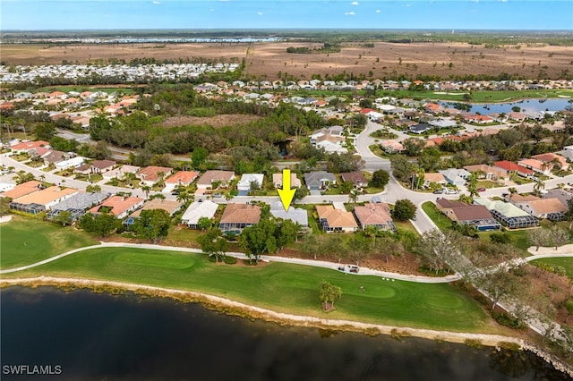 drone / aerial view featuring a residential view, a water view, and golf course view