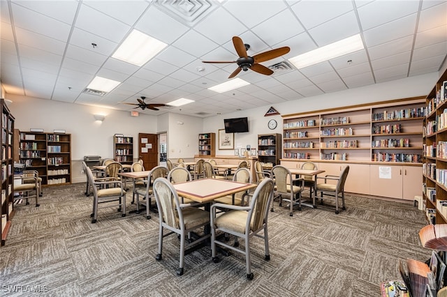 dining space with ceiling fan, carpet, and visible vents