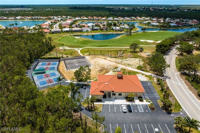 bird's eye view with a water view and golf course view