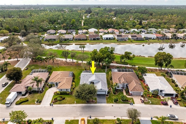 drone / aerial view featuring a water view and a residential view