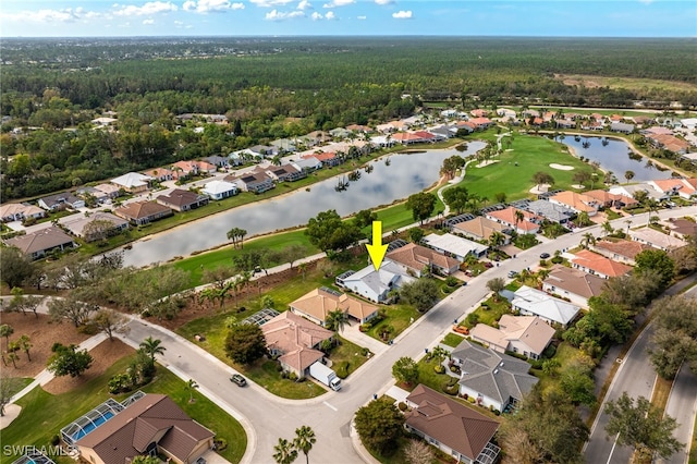 drone / aerial view with a water view and a residential view