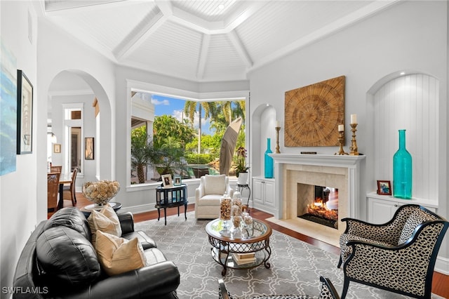 sitting room with lofted ceiling with beams and light wood-type flooring