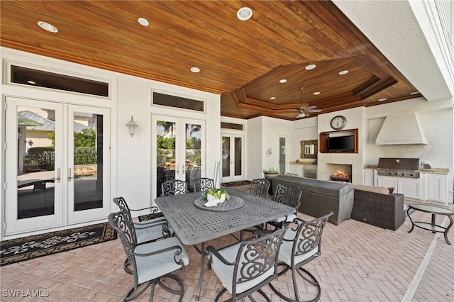 view of patio featuring an outdoor living space with a fireplace, a grill, ceiling fan, and french doors