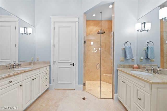 bathroom featuring tile patterned flooring, vanity, and walk in shower