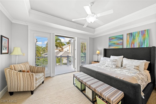 carpeted bedroom featuring access to outside, ceiling fan, crown molding, and a tray ceiling