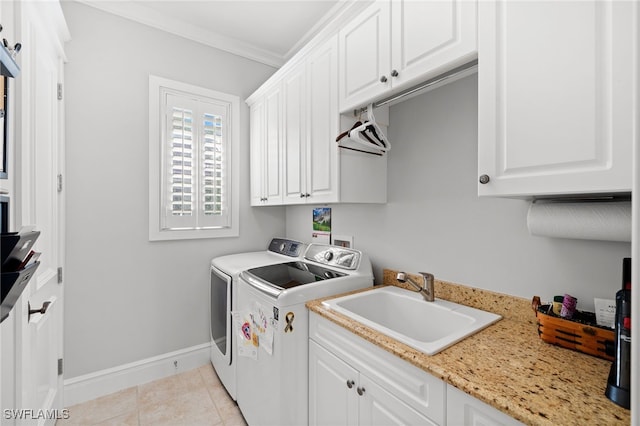 laundry room featuring cabinets, sink, independent washer and dryer, light tile patterned floors, and ornamental molding