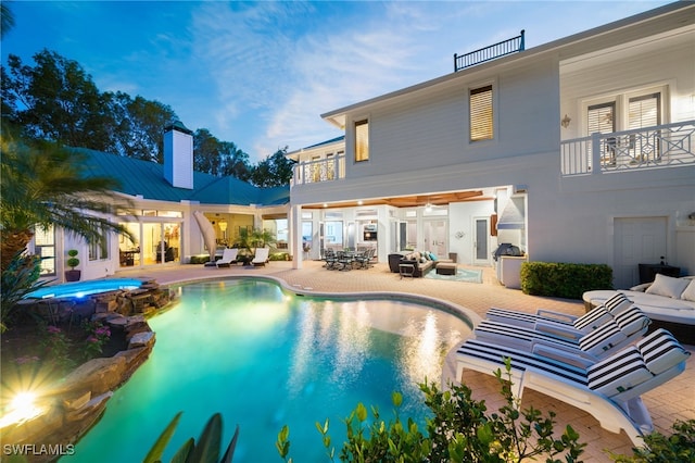 view of swimming pool featuring an outdoor living space, a patio area, and an in ground hot tub