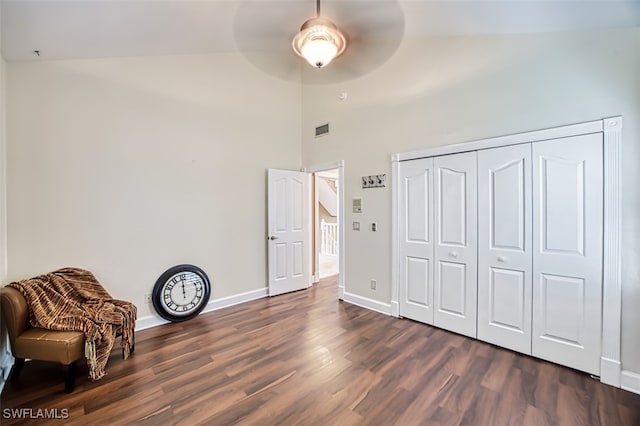 sitting room featuring ceiling fan, dark wood-type flooring, and vaulted ceiling