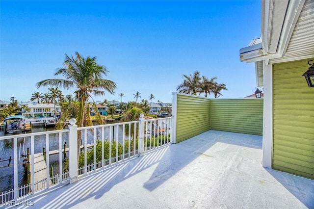 view of patio / terrace with a balcony and a water view