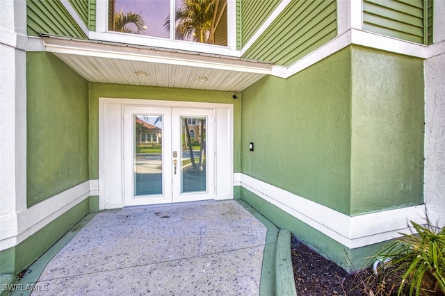 18141 Old Pelican Bay Dr, Fort Myers Beach, FL 33931 - view of exterior entry featuring french doors, stucco siding, and a patio