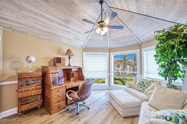 home office with plenty of natural light, ceiling fan, vaulted ceiling, and light hardwood / wood-style flooring