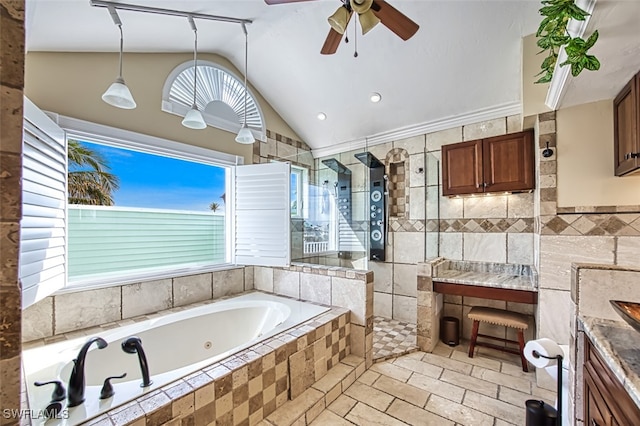 bathroom with vanity, lofted ceiling, tile walls, and independent shower and bath