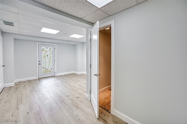 interior space with light hardwood / wood-style flooring and a drop ceiling