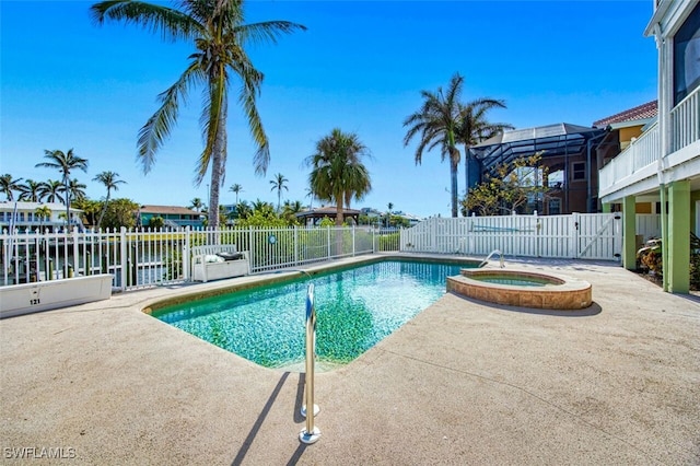 view of pool with glass enclosure, a water view, an in ground hot tub, and a patio