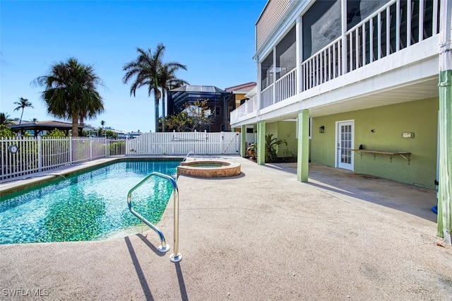 view of swimming pool featuring a patio area, an in ground hot tub, french doors, and a sunroom