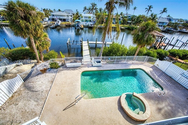 view of pool featuring an in ground hot tub, a dock, a water view, and a patio