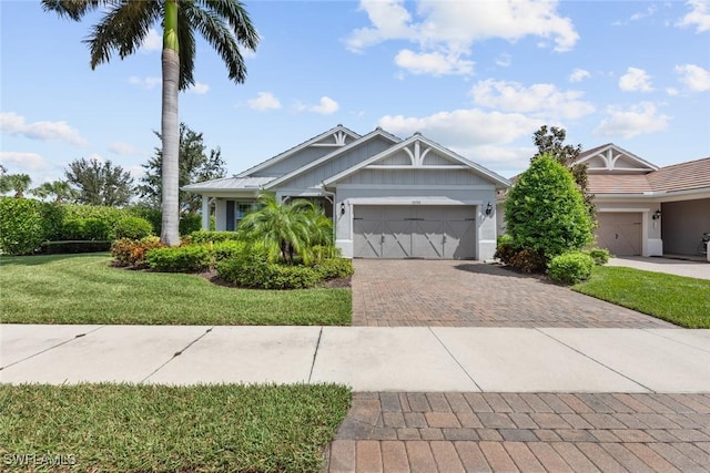 craftsman-style house with a garage and a front lawn