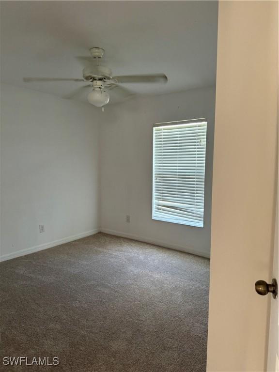 unfurnished room with carpet flooring and ceiling fan