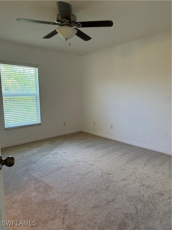 unfurnished room with ceiling fan and light colored carpet