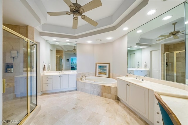 bathroom featuring shower with separate bathtub, vanity, and a raised ceiling