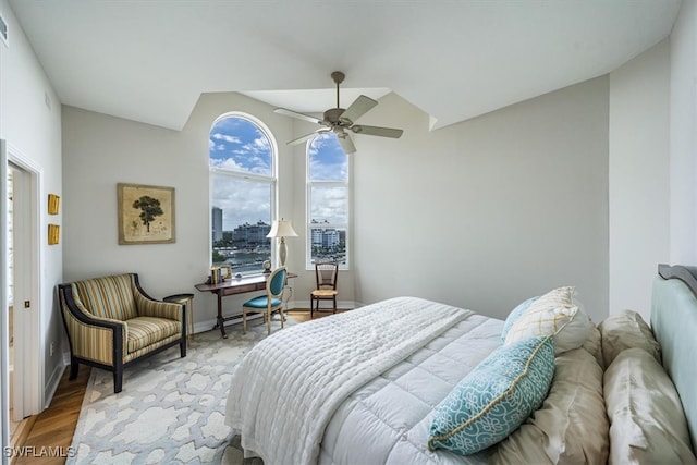 bedroom with hardwood / wood-style flooring, ceiling fan, and lofted ceiling