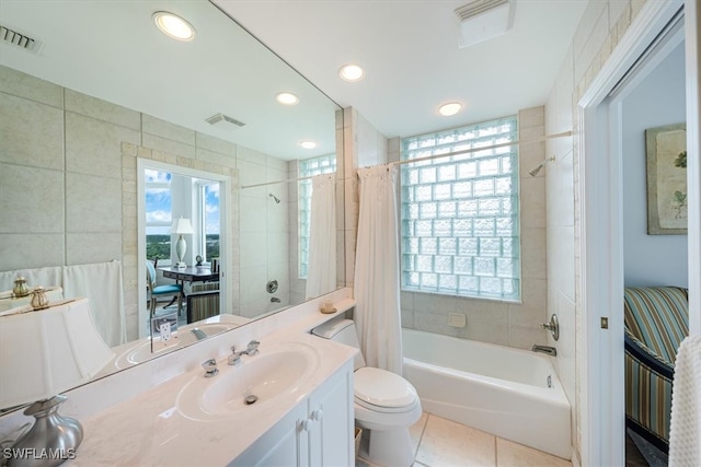 full bathroom featuring tile patterned floors, vanity, shower / bath combo, and toilet