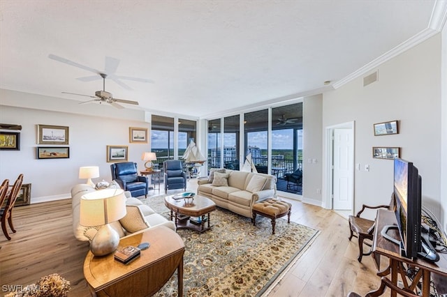 living room with expansive windows, light hardwood / wood-style floors, and ornamental molding